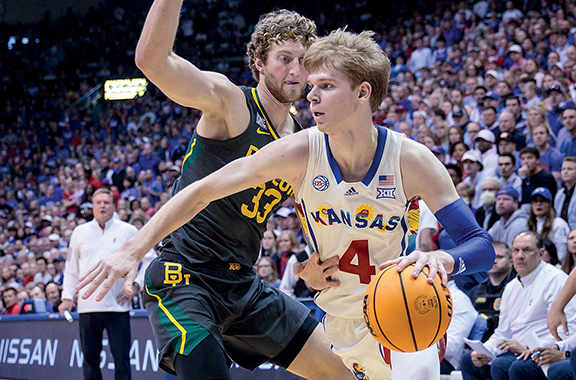 Kansas Jayhawks guard Gradey Dick drives around Baylor Bears forward Caleb Lohner during the second half at Allen Fieldhouse.